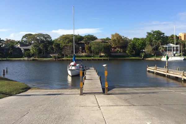 Boat dock with a sail boat tied up on the water